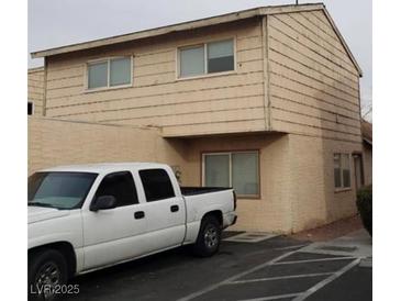 Two story home with light colored exterior and white truck in the driveway at 5126 Golden Ln # A, Las Vegas, NV 89119