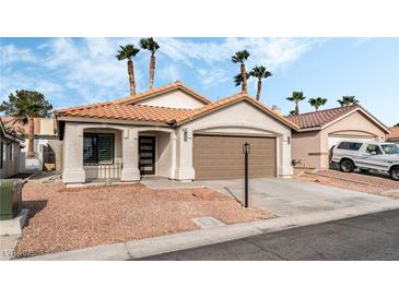 Charming single-story home with a low-pitched tile roof and desert landscaping at 5537 Sentinel Bridge St, Las Vegas, NV 89130