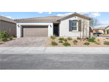 Charming single-story home with a two-car garage and a well-maintained front yard at 6033 Torciano St, North Las Vegas, NV 89081