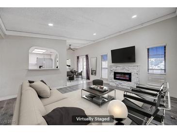 Bright living room featuring a fireplace, wood floors, and plenty of natural light at 6109 W Oakey Blvd # C, Las Vegas, NV 89146