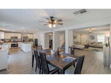Open floor plan showcasing the kitchen and dining area with a ceiling fan and modern decor at 6924 Ghost Ranch Ave, Las Vegas, NV 89179