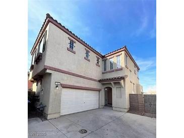 Two-story home featuring a neutral stucco facade, a two-car garage, and a well-maintained front yard at 731 Emerald Idol Pl, Henderson, NV 89011