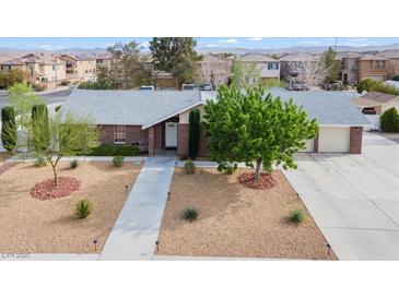 Charming single-story home with a well-manicured, xeriscaped front yard and a brick exterior at 7797 Hauck St, Las Vegas, NV 89139