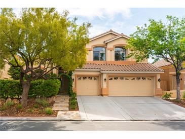 Charming two-story home with a three-car garage, landscaped front yard and well-maintained desert landscape at 812 Eaglewood Dr, Las Vegas, NV 89144