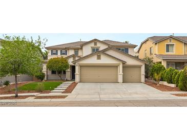 Two-story home featuring a three-car garage, well-maintained lawn and mature landscaping at 10501 Haywood Dr, Las Vegas, NV 89135