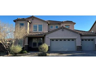 Charming two-story home featuring a three-car garage and well-maintained landscaping at 1209 Equator Ave, North Las Vegas, NV 89032