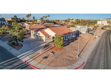 Charming single-story home featuring a well-maintained exterior, desert landscaping, and a convenient circular driveway at 1319 Highland Ct, Boulder City, NV 89005