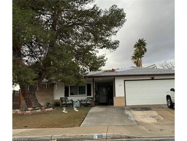 Charming single story home with a two car garage and large shade tree in the front yard at 212 Bradshaw Way, Las Vegas, NV 89145