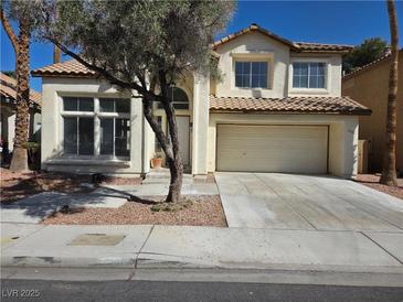 Charming two-story home featuring a tile roof, attached garage, and well-maintained landscaping at 2606 Heartland Ave, Henderson, NV 89074