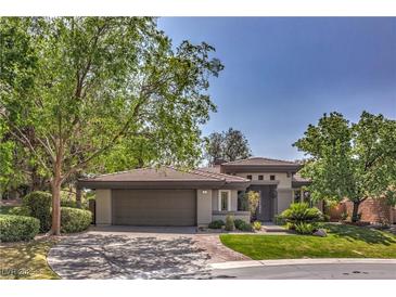Charming single-story home featuring a well-manicured lawn, mature trees, and a covered two-car garage, offering both curb appeal and convenience at 3 Glendora Ct, Henderson, NV 89052