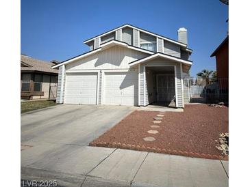 Two story home with a two car garage and neutral colored paint at 3813 Marshall Cir, Las Vegas, NV 89108