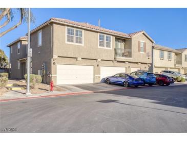 Charming townhome featuring a two-car garage and cozy balcony perfect for enjoying the neighborhood view at 4350 Westbury Square St # 3, North Las Vegas, NV 89032