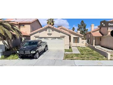 Charming single-story home featuring a two-car garage, desert landscaping, and a welcoming entrance at 4536 Toadstool Ln, Las Vegas, NV 89110