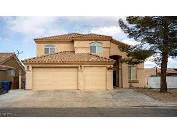 Charming two-story stucco home featuring a tile roof and a spacious three-car garage at 8980 Tumbling Pebble Way, Las Vegas, NV 89123