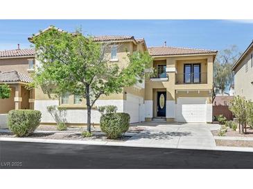 Two-story home featuring a charming balcony, desert landscaping, and a two-car garage with an inviting curb appeal at 9221 Steeltree St, Las Vegas, NV 89143