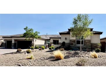 Beautiful single story home with desert landscaping, and a large garage at 9511 Star Vista Ct, Las Vegas, NV 89149