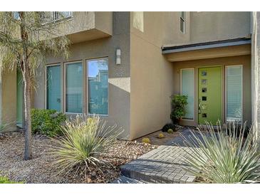 Inviting home exterior featuring a green front door and desert landscaping at 11297 Essence Point Ave # 102, Las Vegas, NV 89135