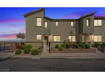 Two-story townhome with desert landscaping, a small front yard, and a private entrance at 12108 Harvest Sky Way # 1, Las Vegas, NV 89183