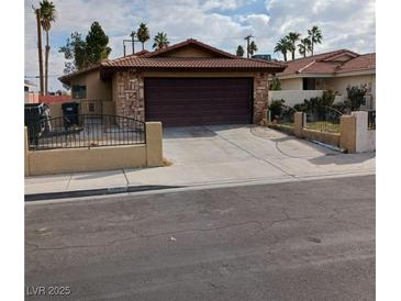 Charming single-story home with a brick facade and a two-car garage at 1732 Yellow Rose St, Las Vegas, NV 89108