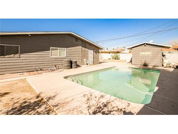 Backyard view showcasing a refreshing in-ground pool and patio area perfect for entertaining at 2540 Eagle St, Las Vegas, NV 89142