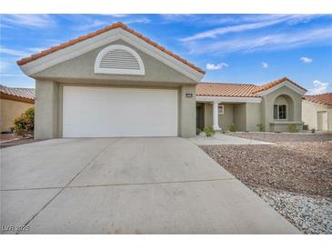 Charming single-story home with a two-car garage, tiled roof, and low-maintenance desert landscaping at 3009 Anna Bay Dr, Las Vegas, NV 89134