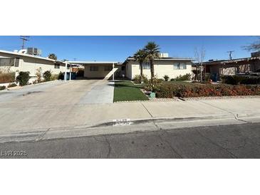 Single story home with desert landscaping and attached carport at 6248 Dayton Ave, Las Vegas, NV 89107