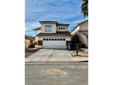 Two-story stucco house with a two car garage and stone accents on the front at 7977 Blue Brook Dr, Las Vegas, NV 89147