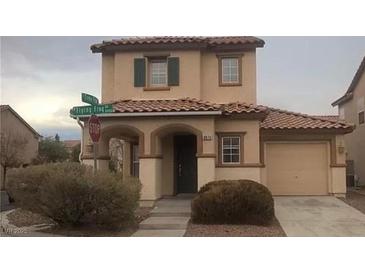 Charming two-story home with a tile roof and well-maintained front yard with stucco facade and attached garage at 8970 Flying Frog Ave, Las Vegas, NV 89148
