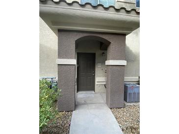 Inviting front entry featuring a covered porch with decorative pillars and a modern door at 9050 W Warm Springs Rd # 1123, Las Vegas, NV 89148