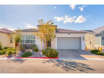 Beautiful single-story home featuring desert landscaping, a two car garage, and a modern stucco facade at 9057 N Skye Treeline St, Las Vegas, NV 89166