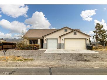 Charming single-story home with a two-car garage and desert landscaping at 1131 S Blagg Rd, Pahrump, NV 89048