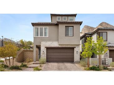 Charming two-story home featuring stone accents, a two-car garage, and a beautifully landscaped front yard at 2367 Ridgeline Wash St, Las Vegas, NV 89138