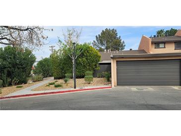 Charming home featuring an attached garage and well-manicured landscaping at 501 Starfire Pl, Las Vegas, NV 89107
