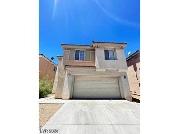 Two-story home featuring a spacious two-car garage and stucco exterior at 5213 Castle Butte Ct, North Las Vegas, NV 89031