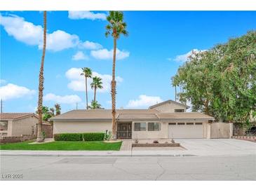 Charming single-story home with desert landscaping, lush lawn, and a spacious two-car garage at 5239 Somerset Dr, Las Vegas, NV 89120