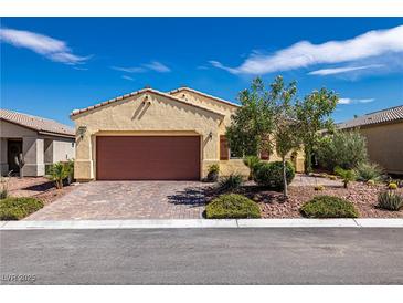 Charming single-story home featuring a well-maintained front yard and a two-car garage with brick-paved driveway at 5524 E San Pietro Dr, Pahrump, NV 89061