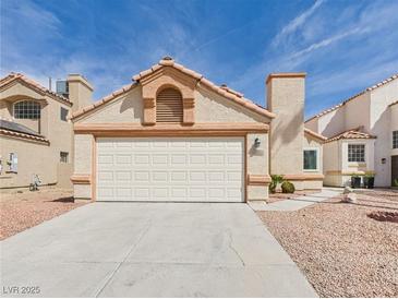 Charming single-story home featuring a two-car garage, stucco walls, and low-maintenance landscaping at 566 Searchlight Dr, Las Vegas, NV 89110