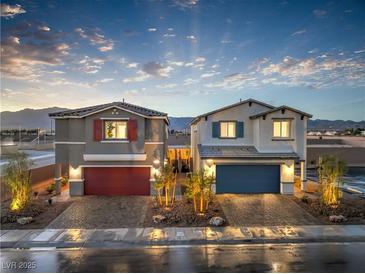 Beautiful matching new construction homes feature desert landscaping and brick paver driveway at 6172 Violet Fls # 42, North Las Vegas, NV 89081