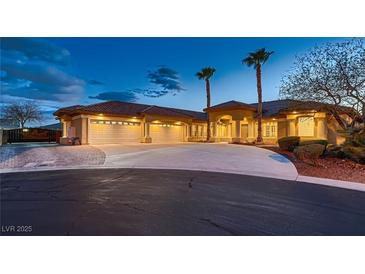 Stunning exterior view of the desert home with a circular driveway and palm trees at 7521 Prancing Pony Ct, Las Vegas, NV 89131