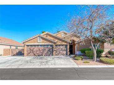 Charming single-story home with a three-car garage and well-maintained landscaping on a sunny day at 8348 Mountain Destiny Ave, Las Vegas, NV 89131