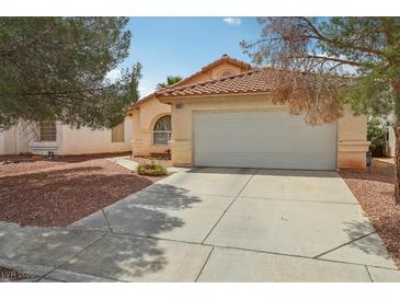 Charming single-story home with a well-maintained lawn and a spacious two-car garage at 9051 Sandy Slate Way, Las Vegas, NV 89123
