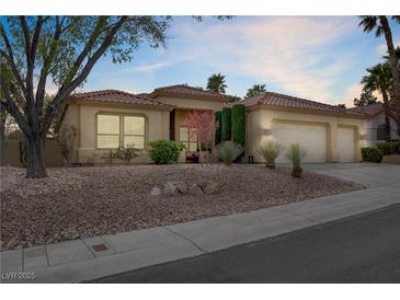 Charming single-story home with a desert landscape and a three-car garage, set against a beautiful dusk sky at 10201 Los Padres Pl, Las Vegas, NV 89134