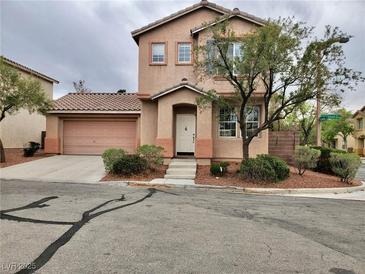 Charming two-story home featuring a tile roof, neat landscaping, and an attached two-car garage at 10719 Tottenham Ave, Las Vegas, NV 89135