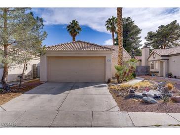 Charming single-story home featuring a two-car garage and desert landscaping at 1709 Autumn Rust Dr, Las Vegas, NV 89119