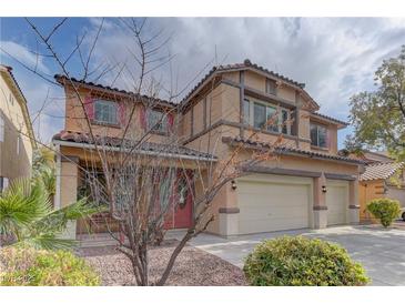 Two-story home featuring a terracotta roof, muted pink shutters, and a three-car garage at 4216 Thunder Twice St, Las Vegas, NV 89129