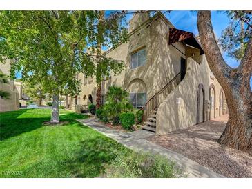 Charming apartment complex featuring stucco exterior, well-maintained landscaping, and mature trees at 5071 Pioneer Ave # 203, Las Vegas, NV 89146