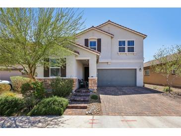 Charming two-story home with a brick driveway and lush desert landscaping at 9625 W Meranto Ave, Las Vegas, NV 89178