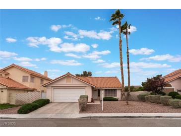 Charming single-story home showcasing a well-maintained front yard, desert landscaping, and a two-car garage at 1335 Heather Oaks Way, North Las Vegas, NV 89031