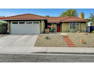 Charming home featuring a red tile roof, desert landscaping, brick walkway and an attached two-car garage at 291 Lido Dr, Henderson, NV 89015