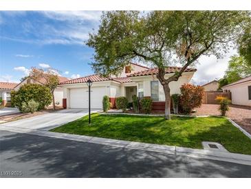 Charming single-story home with a well-maintained lawn, mature tree, and a two-car garage at 3561 Cherbourg Ave, Las Vegas, NV 89141